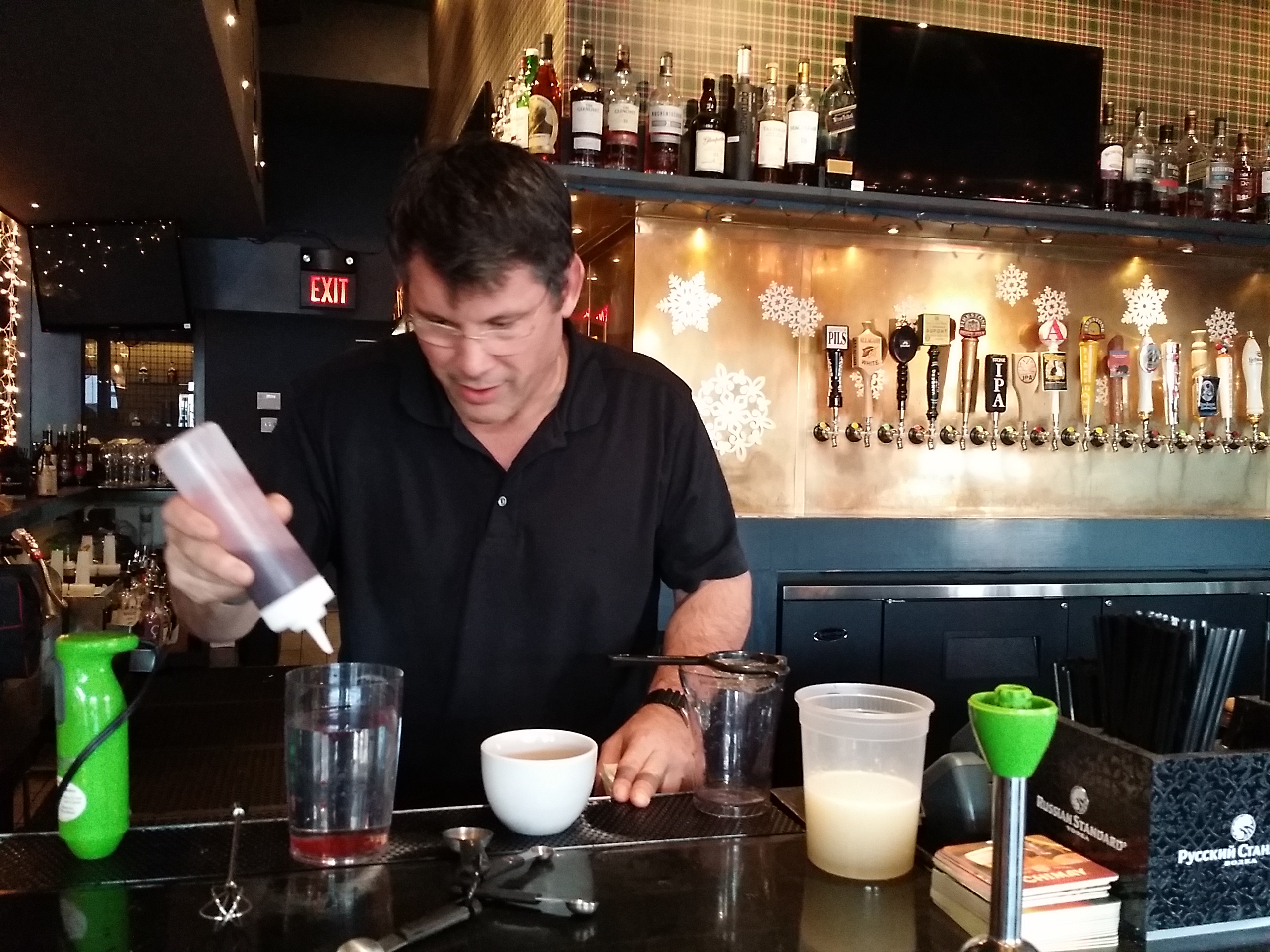 Steven Calabro mixing a cocktail behind the bar